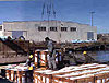 Longshoremen prepare break bulk cargo to be lifted onto a ship.